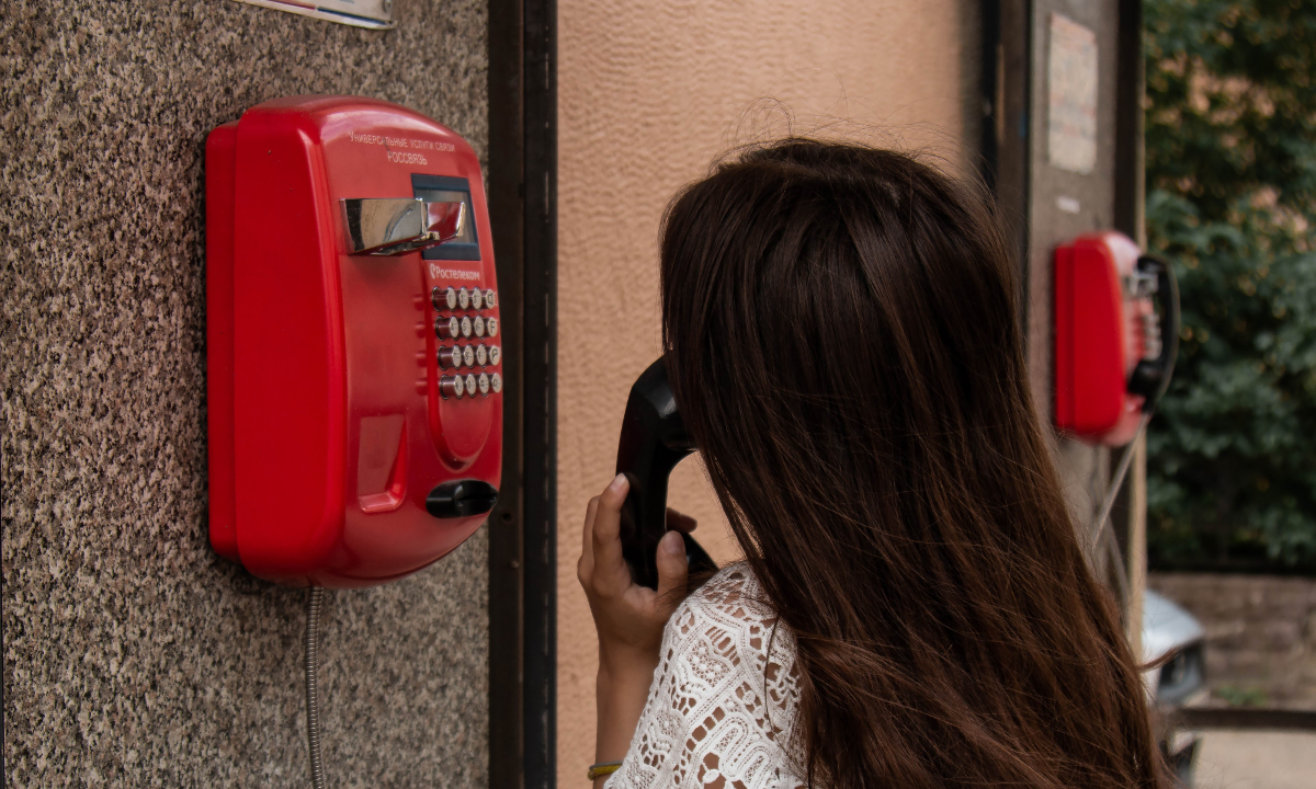 Woman uses payphone