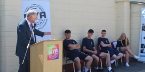 Minister David Stanton gestures towards participants, including Eddie Carey, Darragh O'Keeffe and Lee Quinn